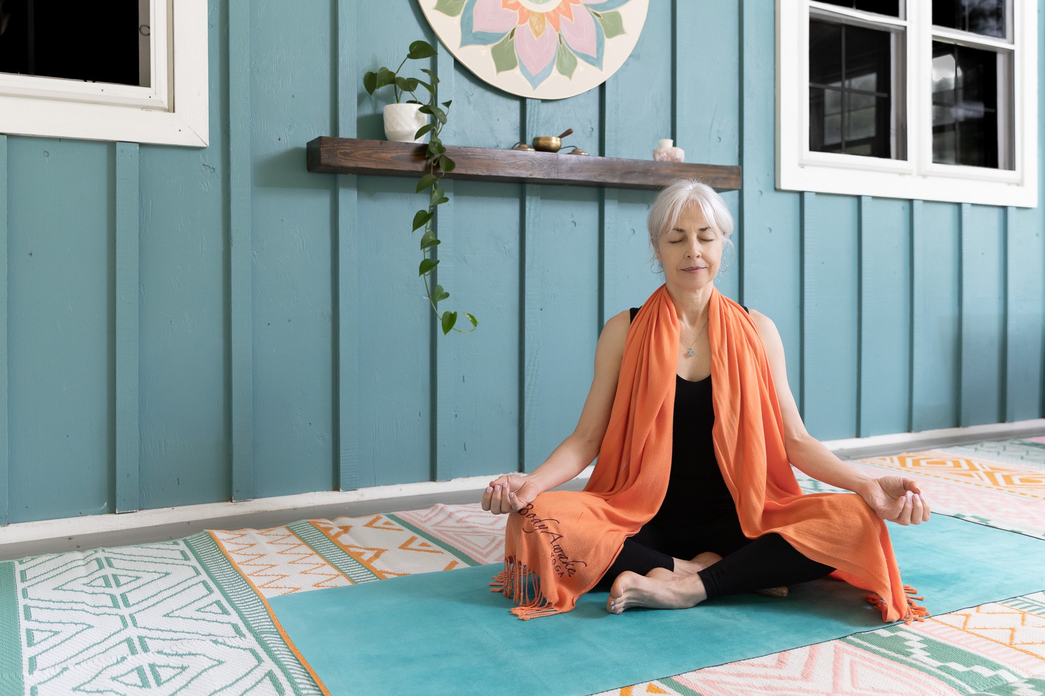 Lori in meditation pose in the barn studio