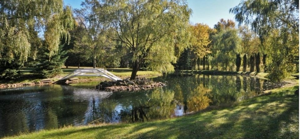 Pond and arched footbridge at Dodeca Waterside Sanctuary