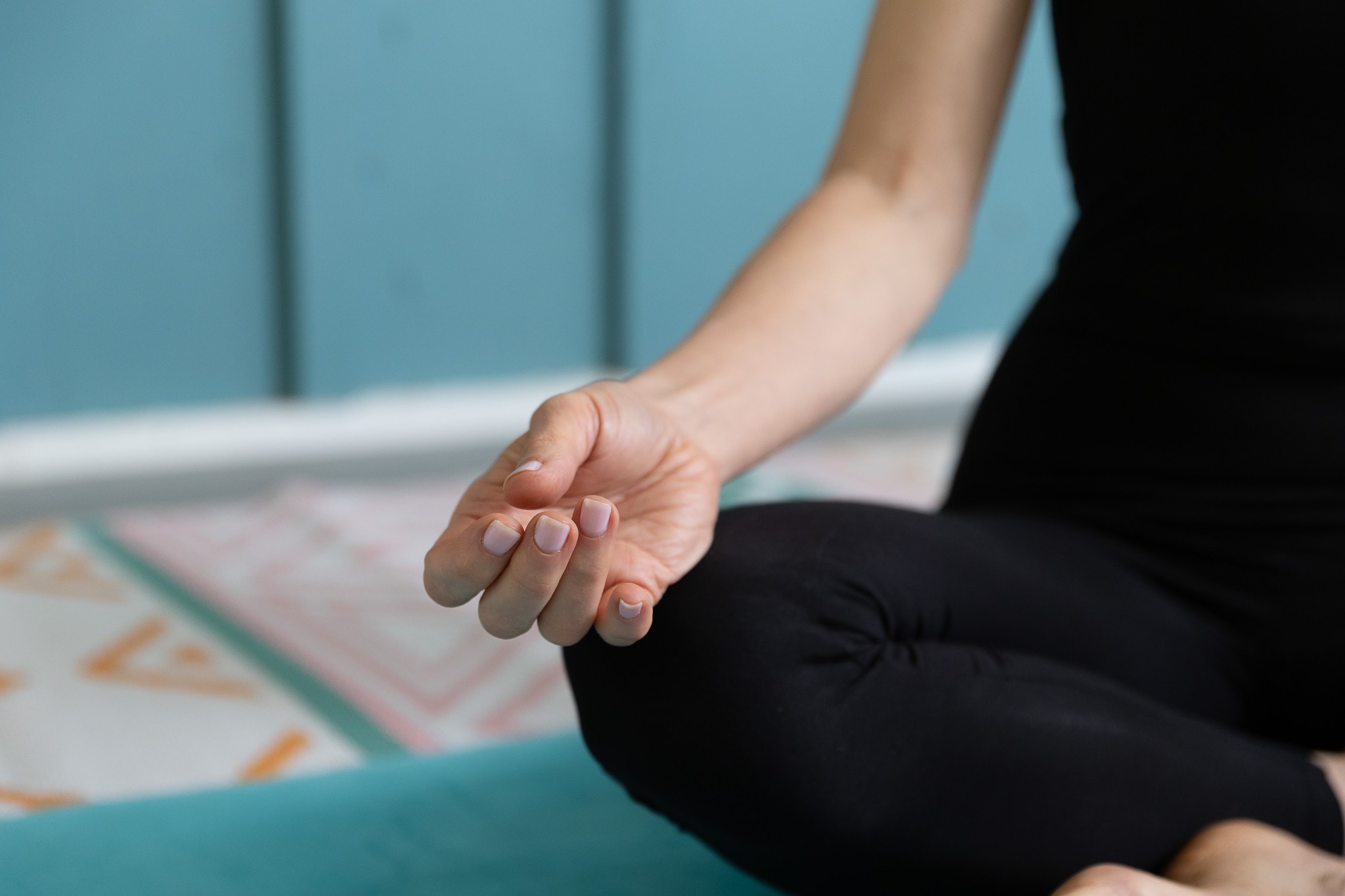 Close-up of hands in a meditative mudra during a yoga session